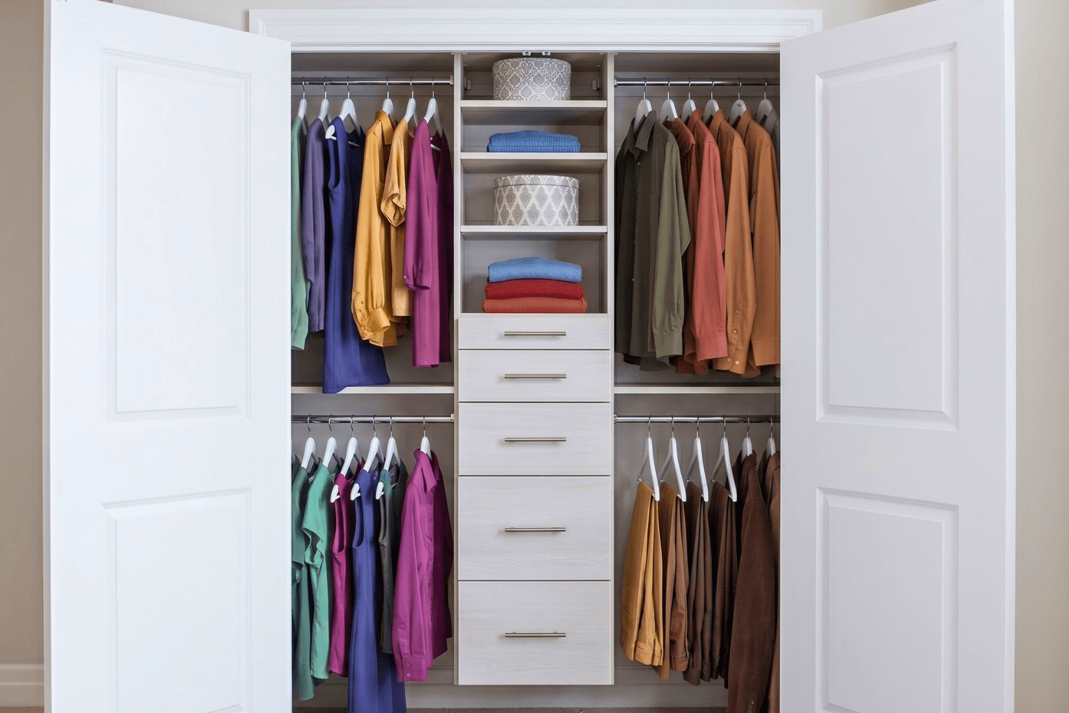 reach-in closet that is organizated with drawers and double hanging clothes.