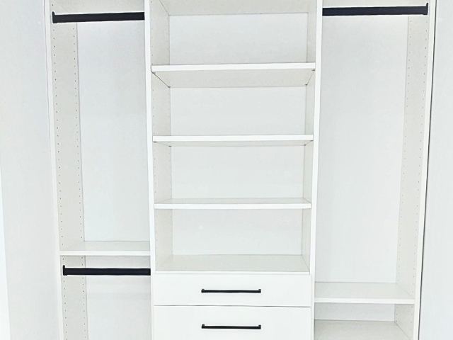 custom white closet with black hanging rods.