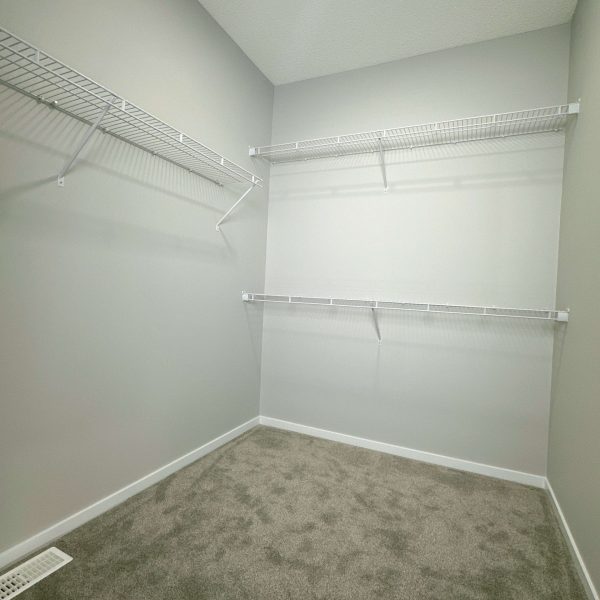 Empty walk-in closet with wire shelves