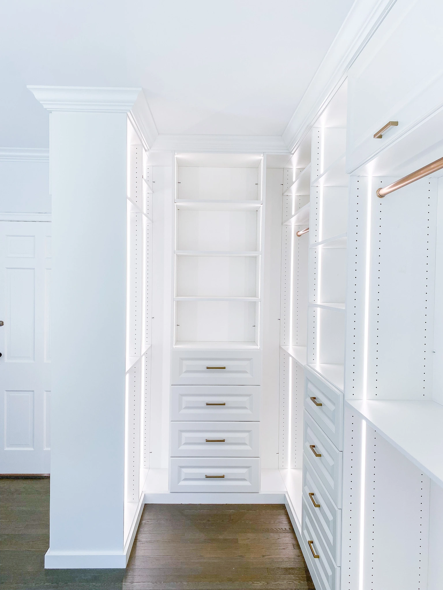 custom-closet-lighting-solutions white walk-in closet with brilliant lighting and premium finishes