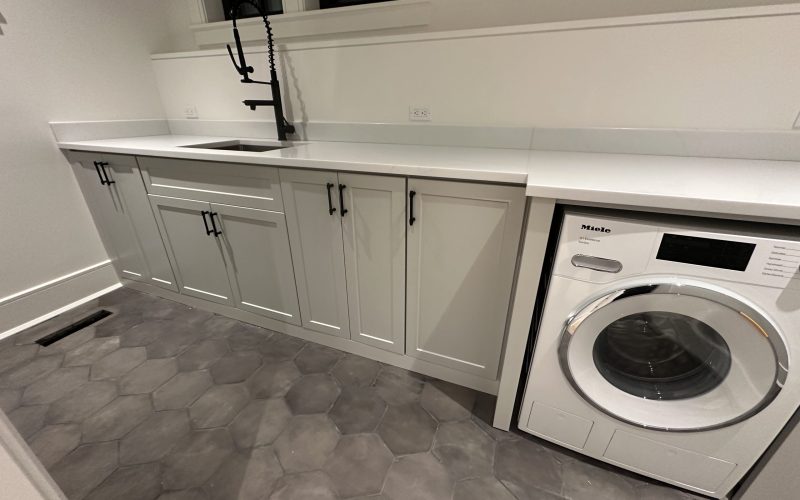 laundry room cabinets with washer, dryer and sink