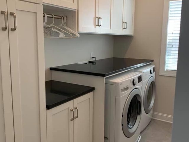 built-in laundry room with custom cabinets